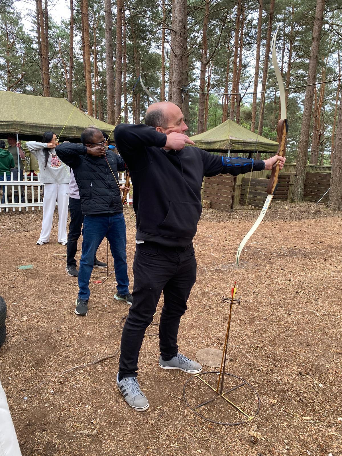 Archer drawing a recurve bow on the woodland archery range