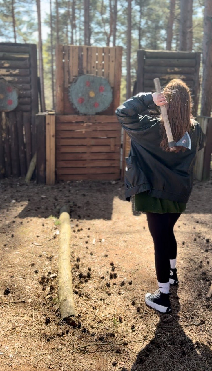 Teen participant taking part in axe throwing