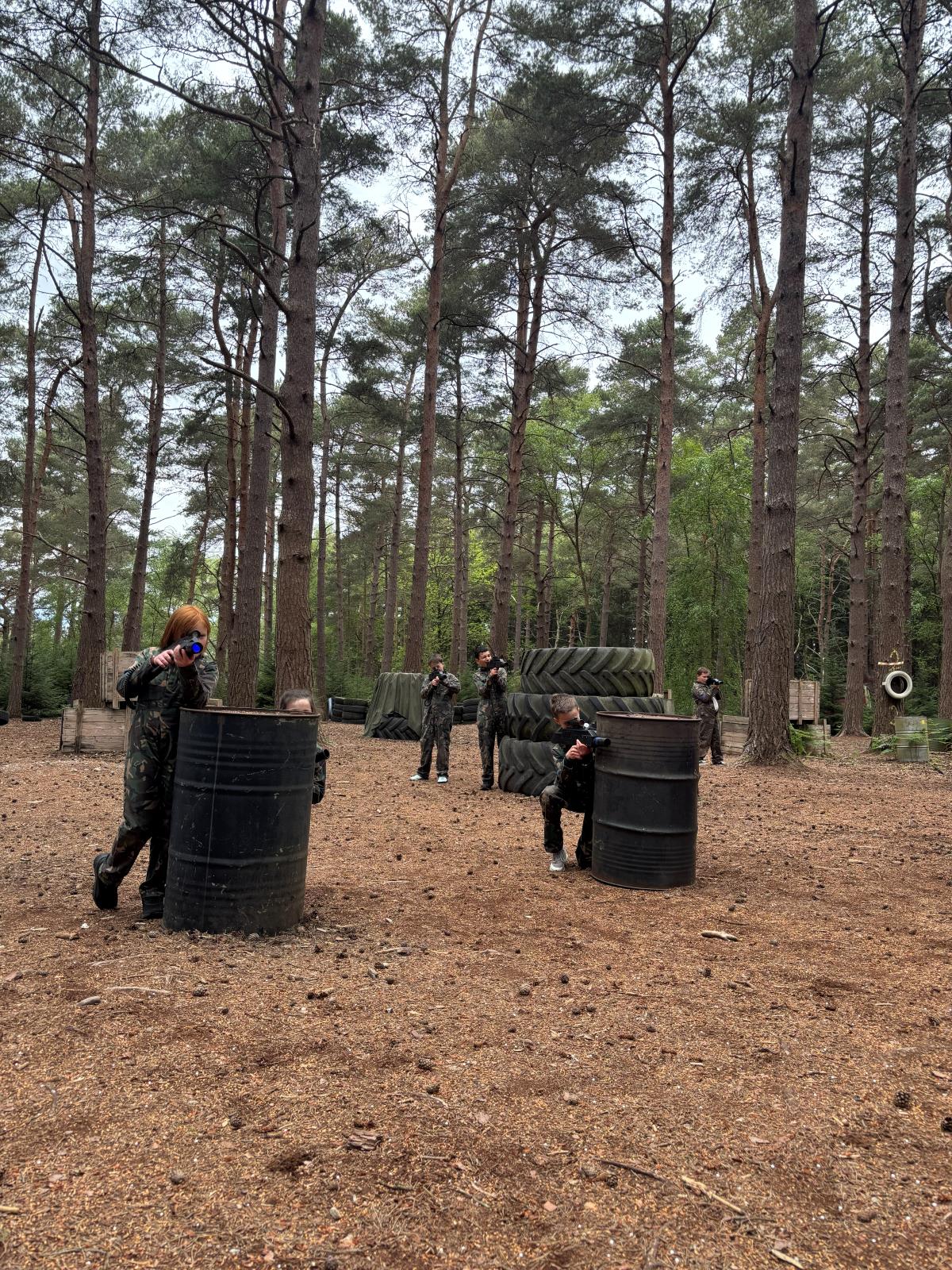 Adult player crouched behind cover during a Hyper Shock laser tag game