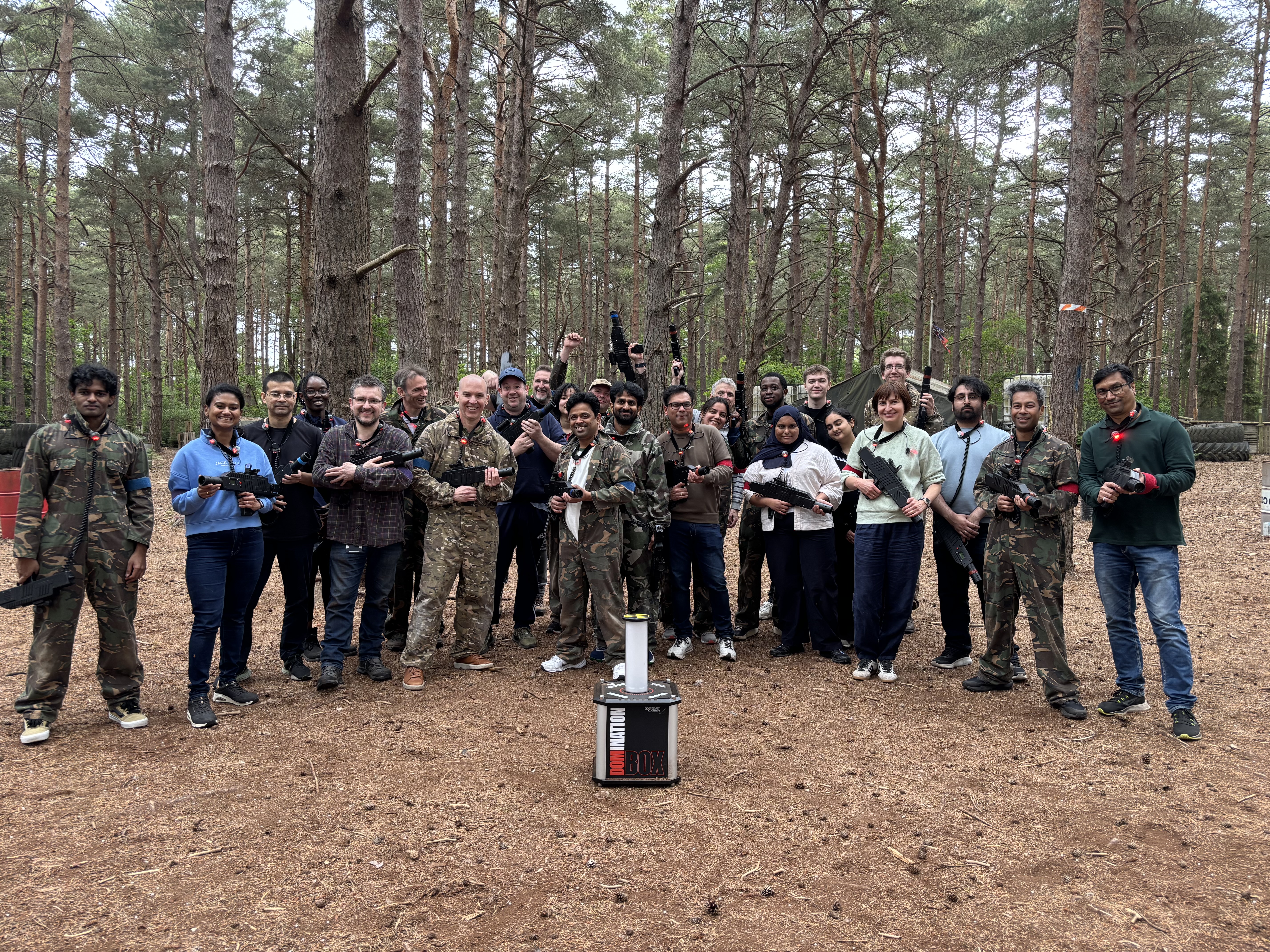 Corporate group with laser rifles during a team away day in the woods