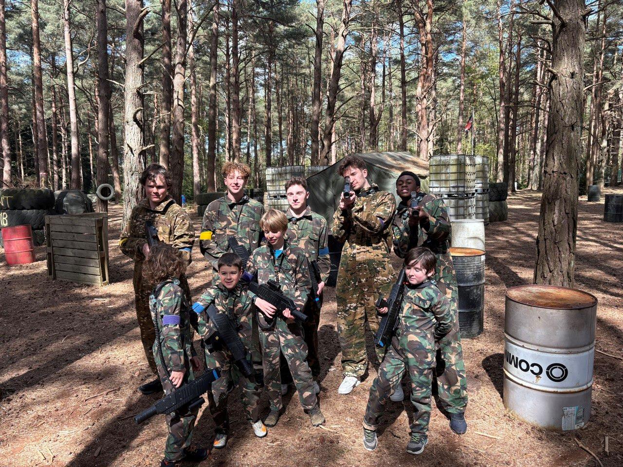 Mixed group of players advancing through the woodland laser tag arena