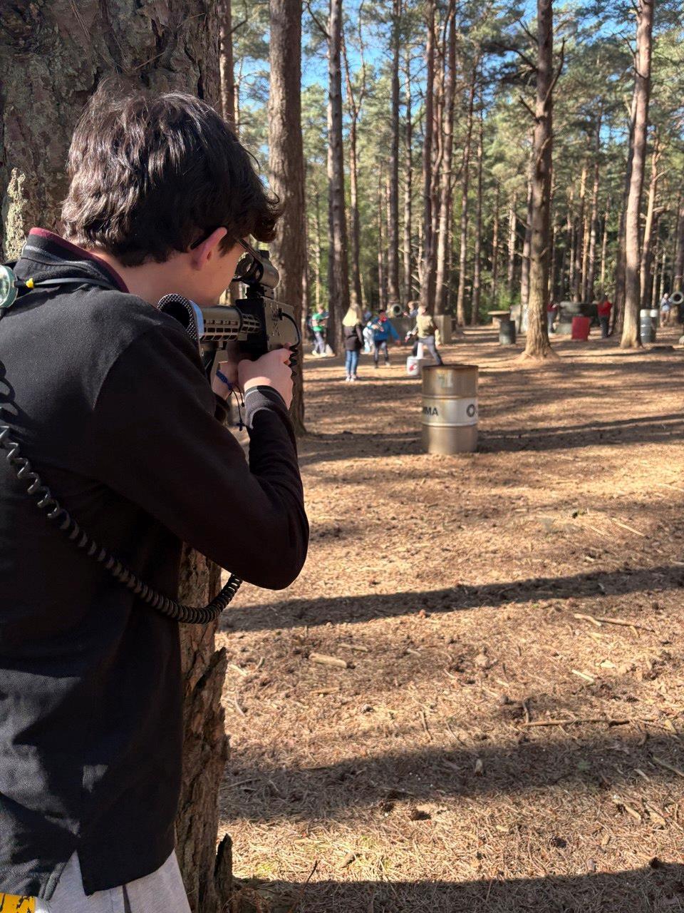 Player aiming a laser rifle from behind cover